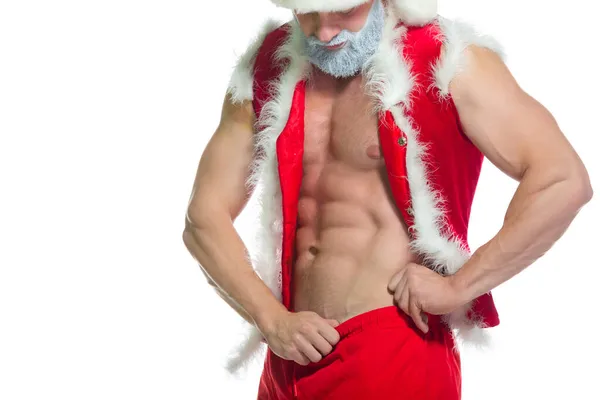 Kerstmis. Portret van gespierde sexy sterke atleet in Santa Claus kostuum met grijze baard poseren tonen zijn buikspieren geïsoleerd op witte achtergrond — Stockfoto