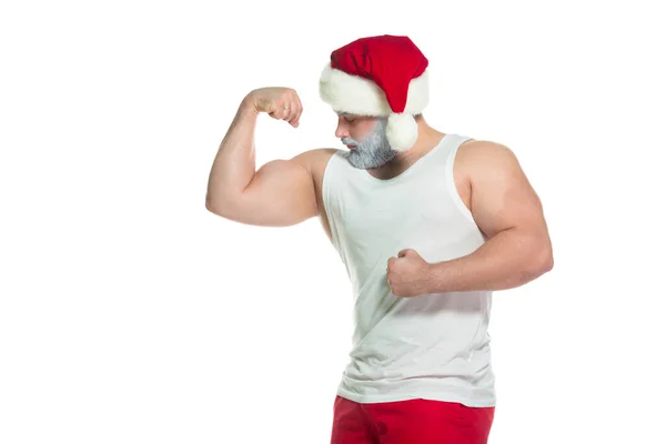 Navidad. Retrato de atleta musculoso sexy fuerte disfrazado de Santa Claus con barba gris posando mostrando sus bíceps aislados sobre fondo blanco — Foto de Stock
