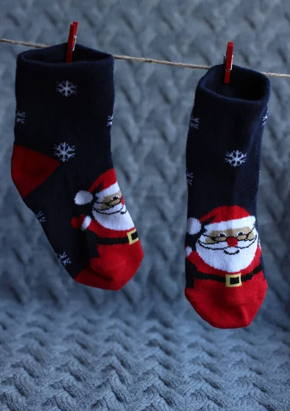 Festive childrens socks with santa clauses on a gray background — Stock Photo, Image