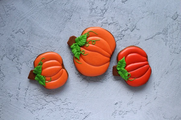 Gingerbread hand-painted in the form of pumpkins on a light background Stock Image