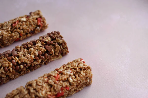 Cereal fitness bars with berries on a purple background with a copy space — Stock Photo, Image