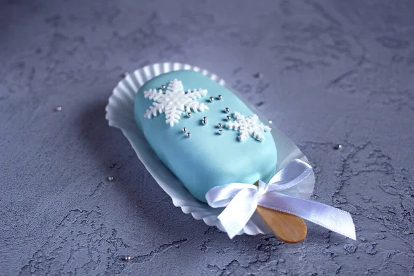 Nyår festlig kaka i glasyr på en pinne på en blå bakgrund — Stockfoto