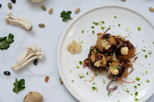 stock image A plate of takoyaki over a marble table