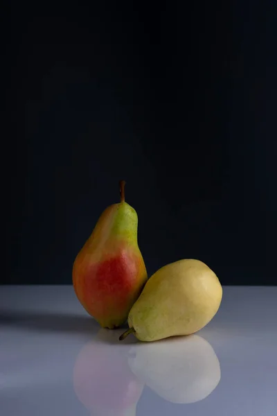 pears minimalistic still life on a dark background.