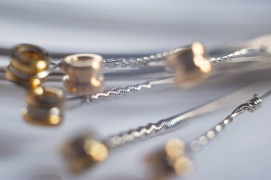 macro details of strings for electric guitar on a white background.