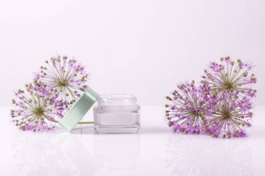 cosmetic cream with flowers on a white background. Face and hand skin care. Natural cosmetic.