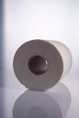 Roll of white disposable nonwoven fabric napkins isolated on white.