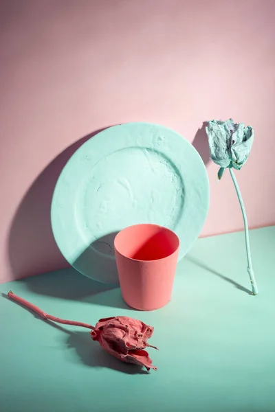 green and living coral color minimalist still life of dishes and roses painted.