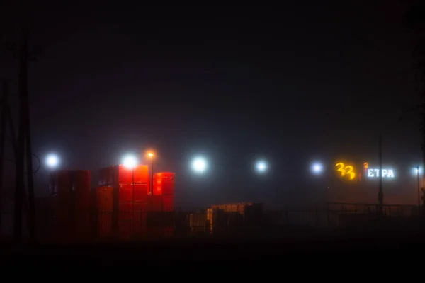 landscape foggy night deserted road with lanterns.
