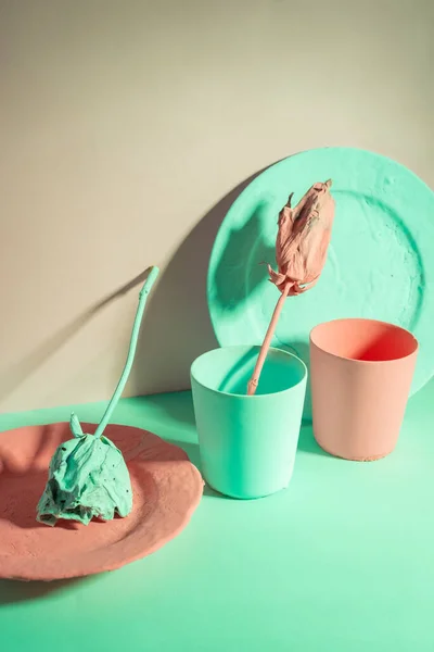 green and living coral color minimalist still life of dishes and roses painted.