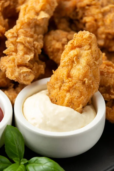 Fried Chicken strips with ketchup and mayonnaise on black plate. Fast Food — Stock Photo, Image