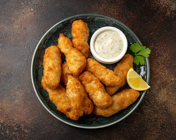 Crispy Fish strips with tartar sauce in a plate — Stockfoto