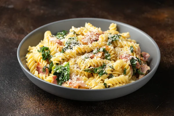 Fusilli pasta with bacon, kale and parmesan cheese. Healthy food — Stockfoto