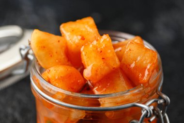 Korean fermented Radish Kimchi in glass jar. Healthy food