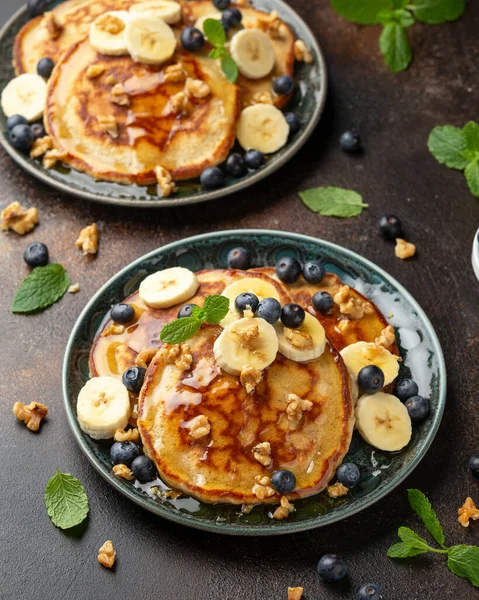 American pancakes with banana, blueberry, walnut and honey. Healthy morning breakfast.