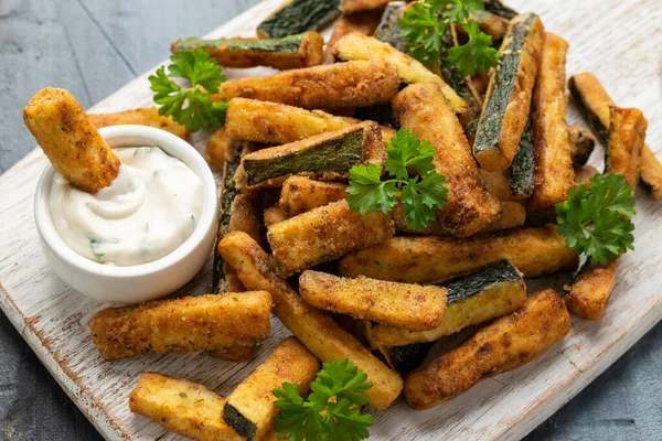 Crispy zucchini fries with sauce in white wooden board — Stok fotoğraf