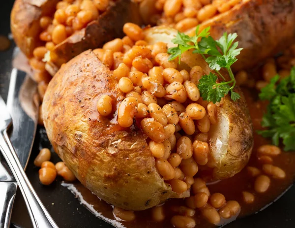 Jacket Baked potato with tomato beans. Traditional British food.