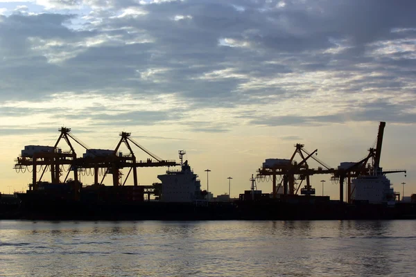 Port warehouse with container cargo and crane bridge Stock Photo