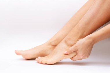 cropped image of female barefoot feet on white background
