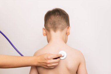 doctor with stethoscope checking kid on white background
