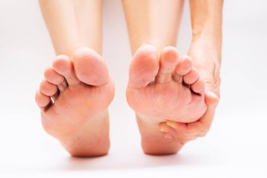 cropped image of female barefoot feet on white background