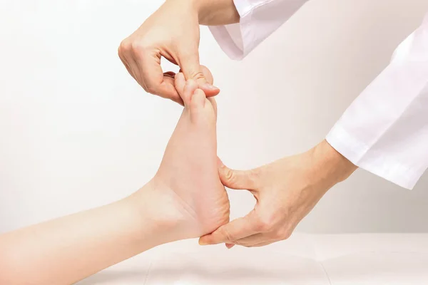 Woman Applying Massage Kid Feet White Background — Stockfoto