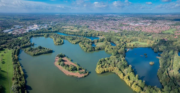 Beautiful aerial view of the Dinton Pastures Country Park, Black and White Swan Lake, and Winnersh Triangle, UK