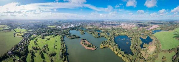 Beautiful aerial view of the Dinton Pastures Country Park, Black and White Swan Lake, and Winnersh Triangle, UK