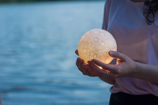 Close up moon in womans hands. Astrology concept. Copy space