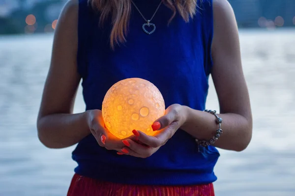 Close up moon in womans hands. Astrology concept. Copy space