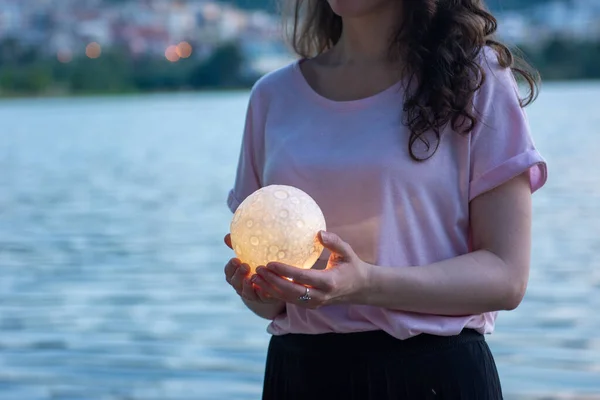 Close up moon in womans hands. Astrology concept. Copy space