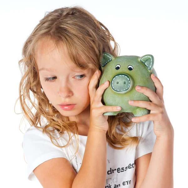 非常に小さな女の子と貯金箱 — ストック写真