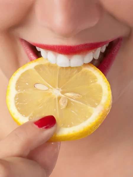 Slice a lemon in the mouth Stock Image