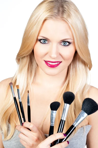 Beautiful woman with makeup brushes — Stock Photo, Image