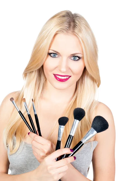 Beautiful woman with makeup brushes — Stock Photo, Image