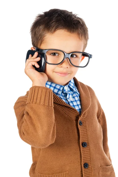 Niño en gafas con el teléfono sobre un fondo blanco —  Fotos de Stock