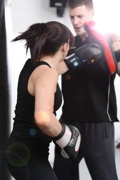 Action shot punching the pads — Stock Photo, Image