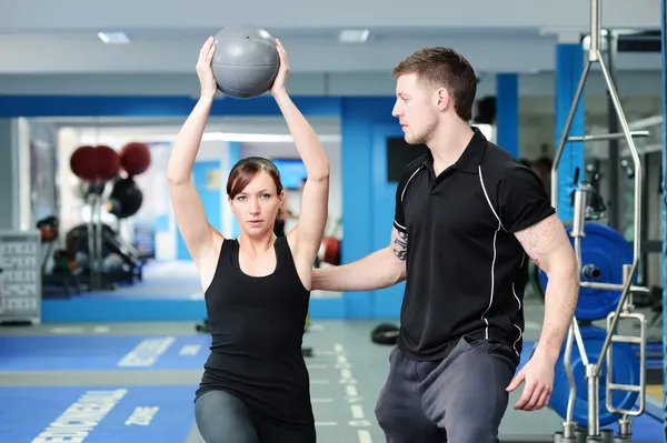 Using medicine ball with personal trainer — Stock Photo, Image