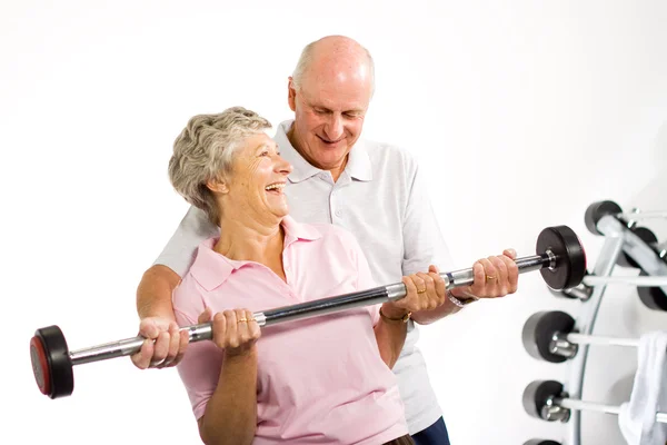 Mature older couple lifting weights — Stock Photo, Image