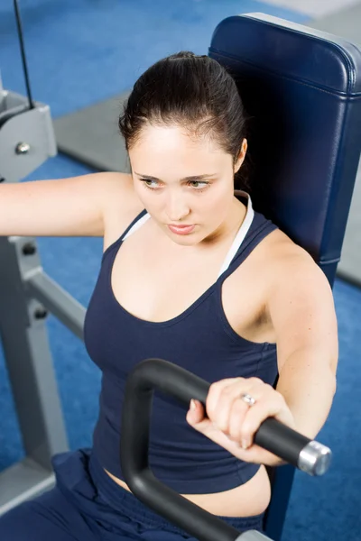 Jovem mulher se exercitando no ginásio — Fotografia de Stock