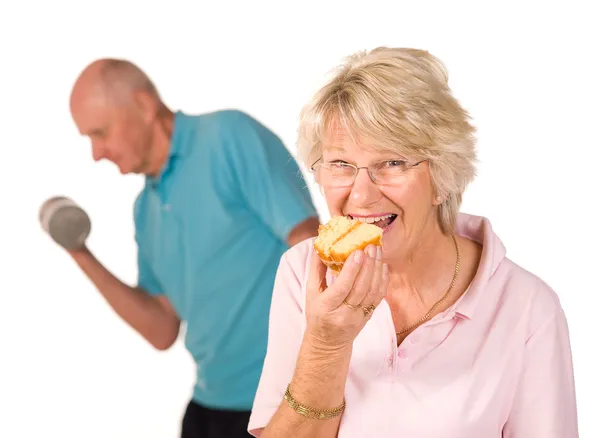 Mature lady cheating on diet — Stock Photo, Image