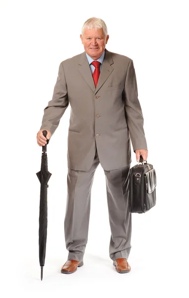 Успешный зрелый бизнесмен с зонтиком и портфелем — стоковое фото