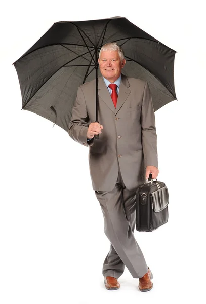 Successful mature businessman with umbrella and briefcase — Stock Photo, Image