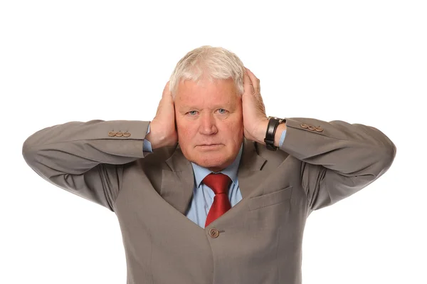 Successful mature businessman covering ears — Stock Photo, Image