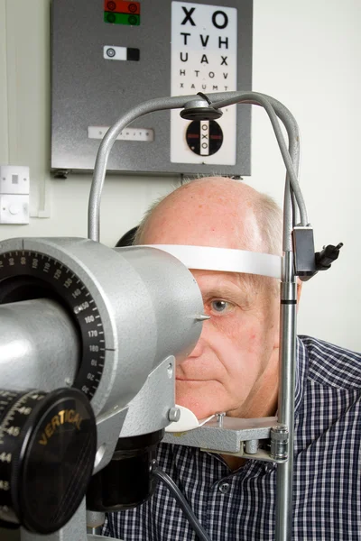 Hombre mayor examinándose los ojos —  Fotos de Stock