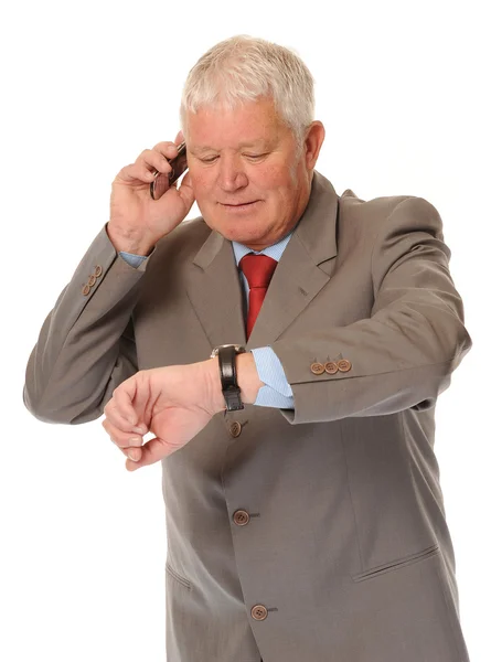 Успішний зрілий бізнесмен за допомогою телефону Стокове Зображення