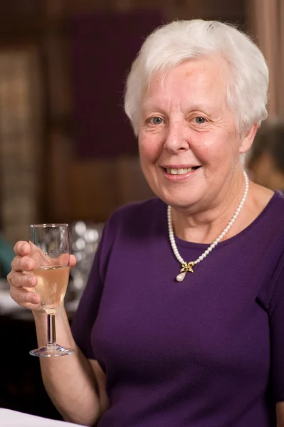 Happy senior lady in restaurant Royalty Free Stock Images