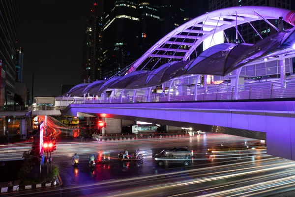 Cityscape of Bangkok at Night with Illumination of Skywalk and Vehicles