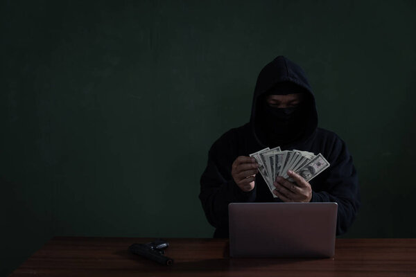 Black Hat Hacker Counting Banknote While Hacking Information Fro