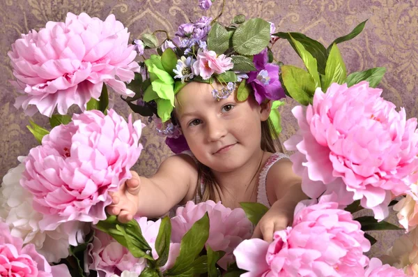 Little girl with big flowers around — Stock Photo, Image